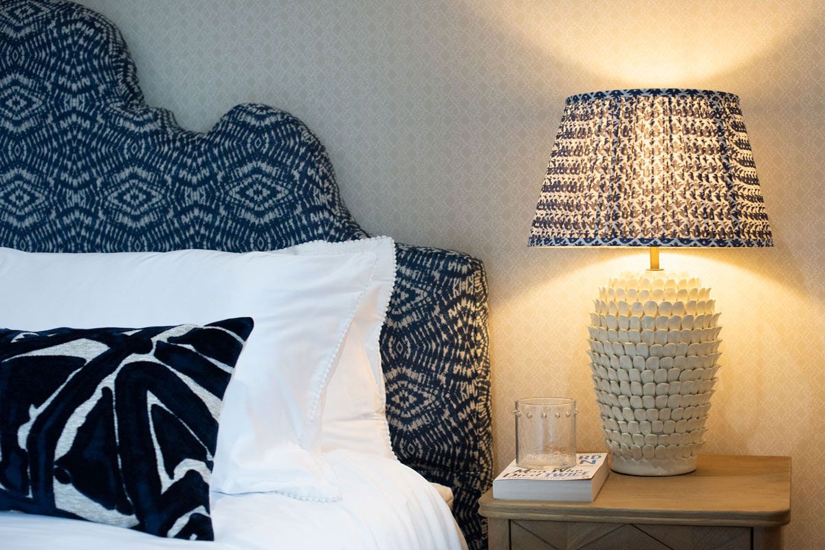 blue-headboard-and-pooky-lamp-detail-master-bedroom